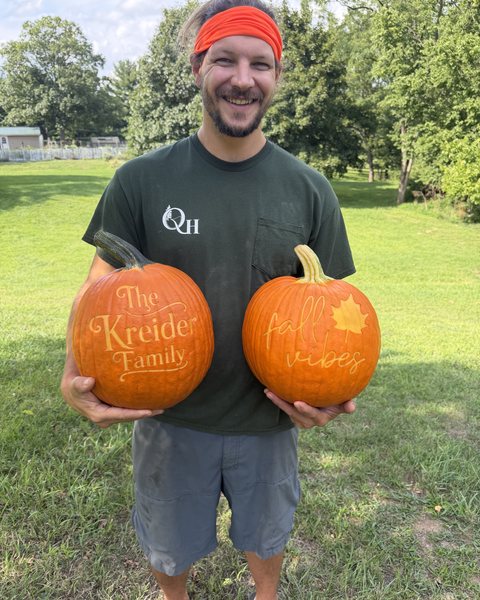 Mike holding two of his engraved pumpkins