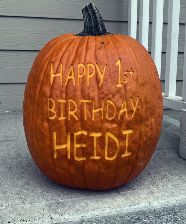 A pumpkin laser-engraved with Happy 1st Birthday Heidi